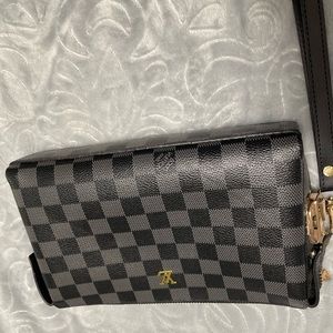 Black and gray checkered clutch handbag with wristlet